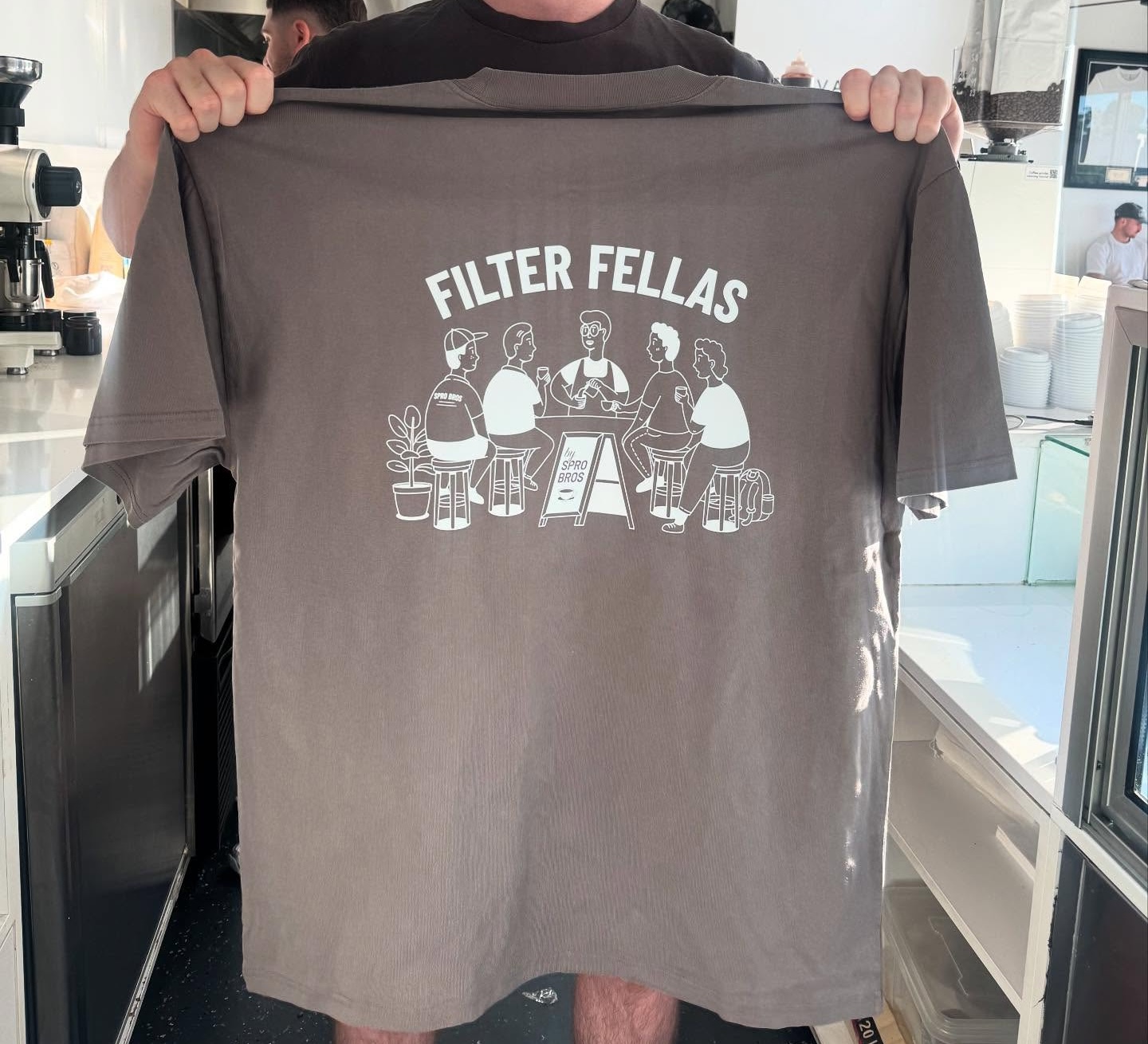 Filter Fellas shirt held up at Elevate Specialty Coffee